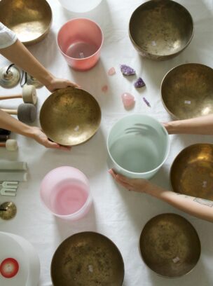 Hands,Holding,Crystal,And,Tibetan,Singing,Bowls.,Overhead,View,With